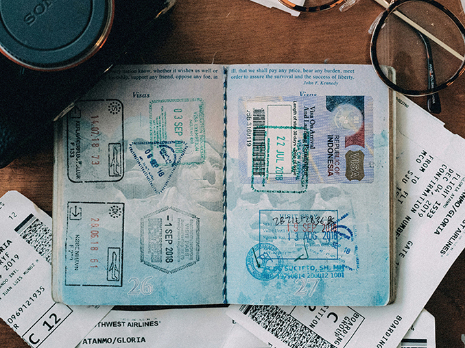 Passport and travel papers laid out on a table, symbolizing the practical steps missionaries take as the church prays for those being sent.